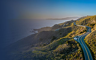 34391 Highway 1 winding through a hilly, coastal countryside