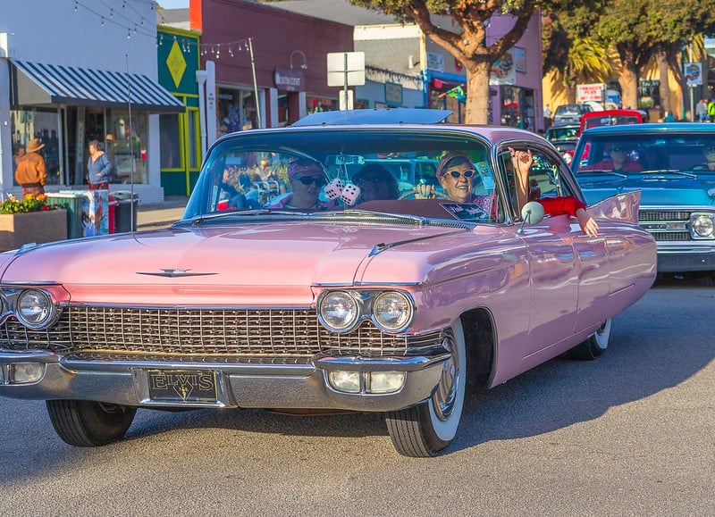 Vintage cars driving down the street