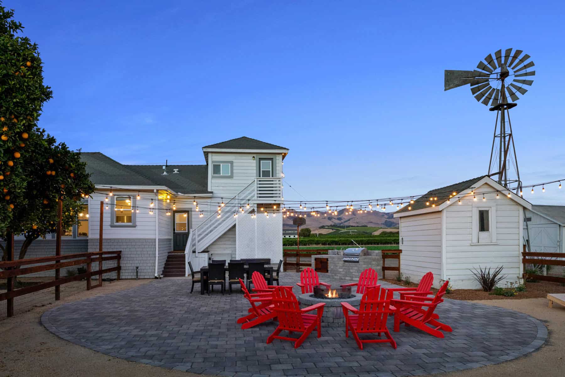 Cozy backyard with red chairs and string lights