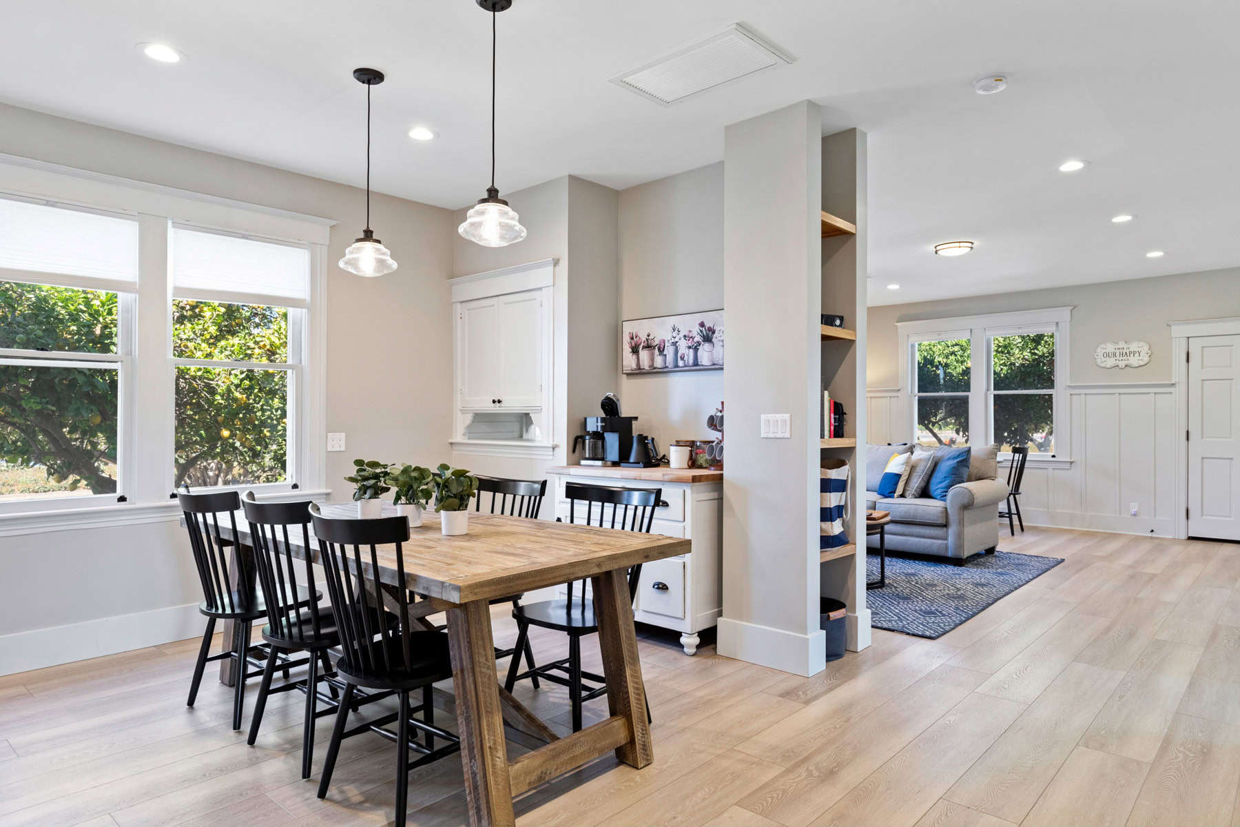 Modern dining area and living room with natural light.