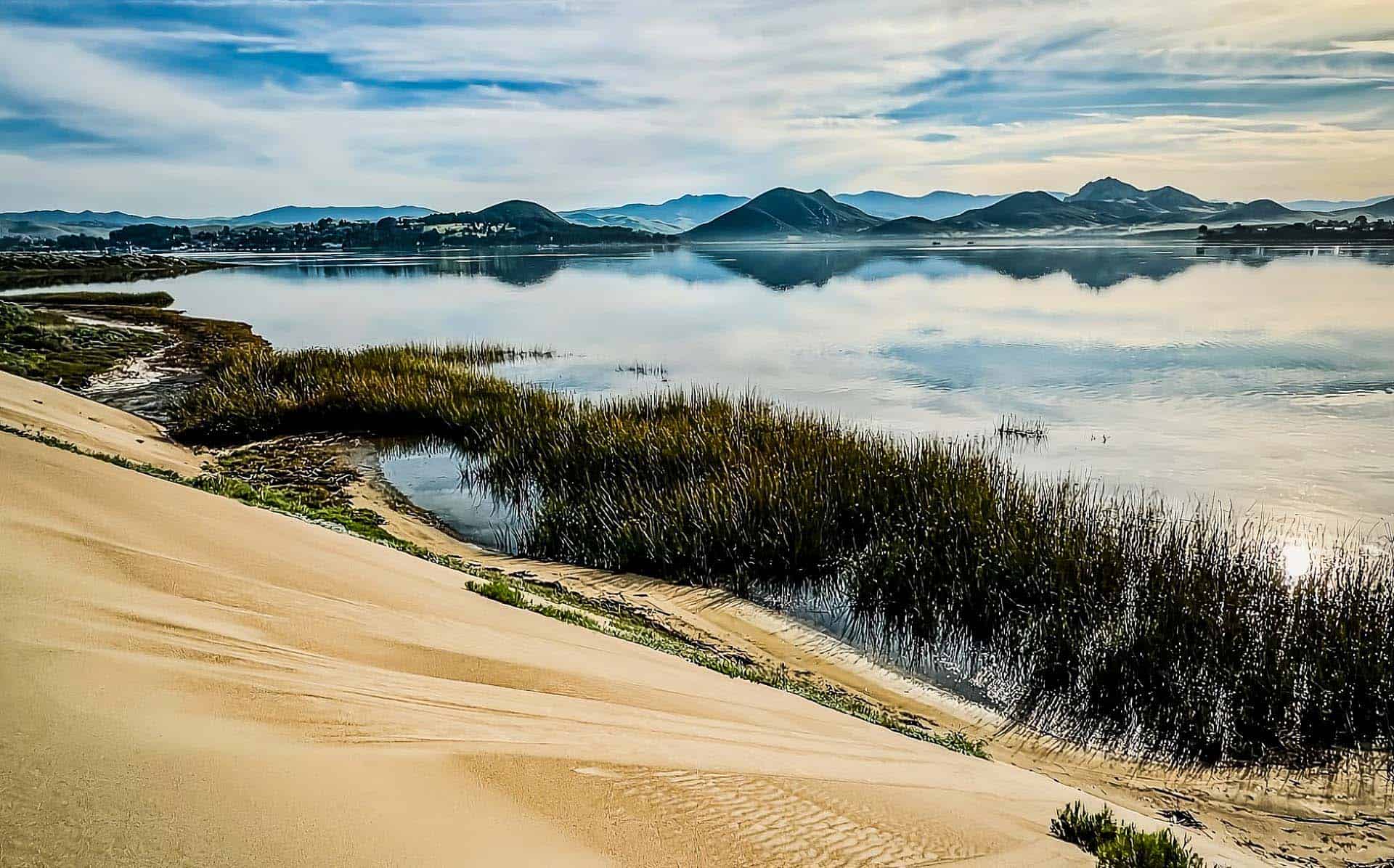 a landscape of a beach and water with hills in the back in Baywood CA